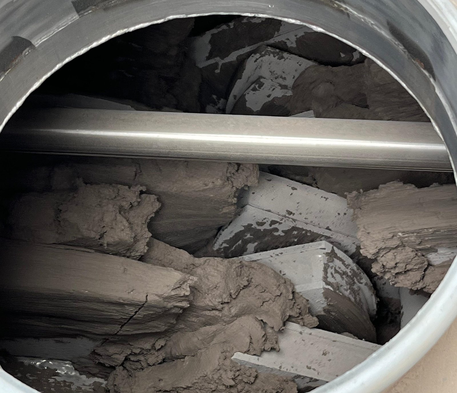 Sticky sludge material inside a paddle dryer